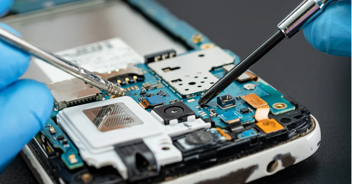 A technician repairing the hardware of an android phone