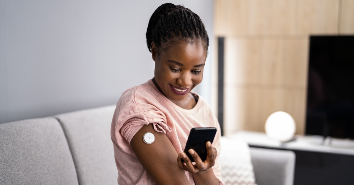 A woman uses a Remote Patient Monitoring Device