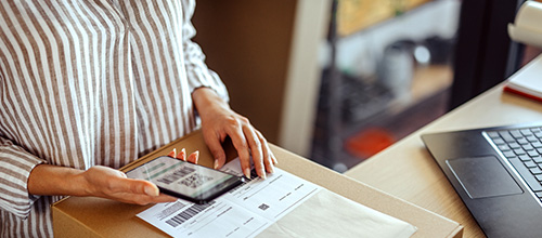 woman using smartphone for barcode scanning