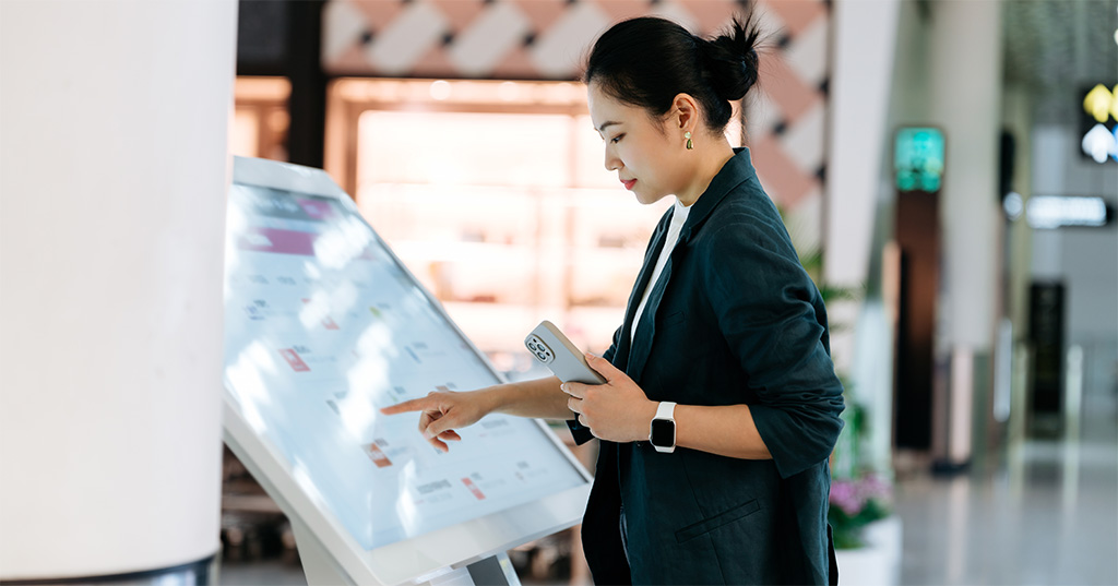 Woman Using Digital Kiosk